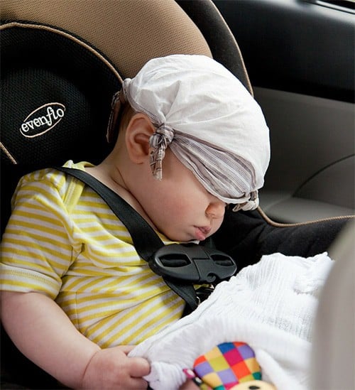 Baby boy is sleeping at evenflo car seat