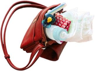diaper bag overflowing with diapers, pacifier, burp cloth and toys