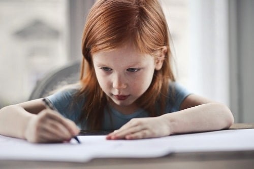 Girl writing on paper