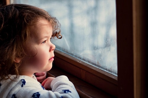 Baby at the windows with serious face