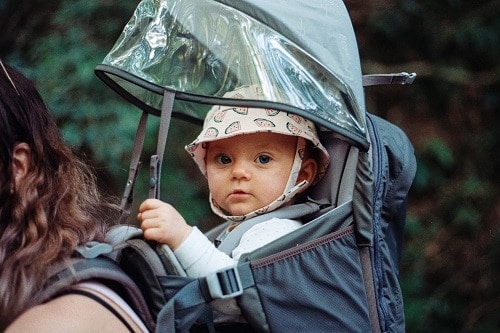 baby inside black backpack carrier