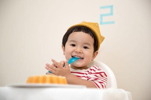 Baby sitting on a white chair