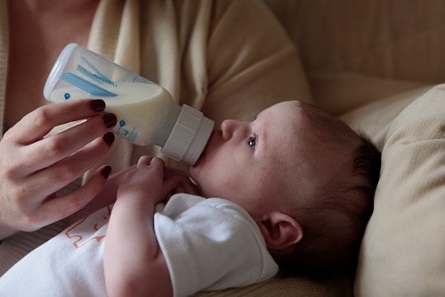 person holding baby bottles