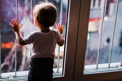 Baby on the windows with grill