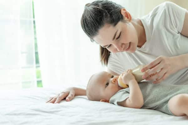 Mother Feeding Baby with Milk in the bottle
