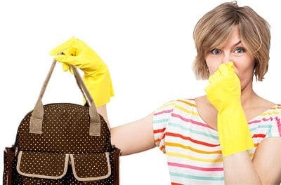 mother holding a smelly diaper bag