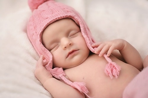 Baby sleeping with pink hat