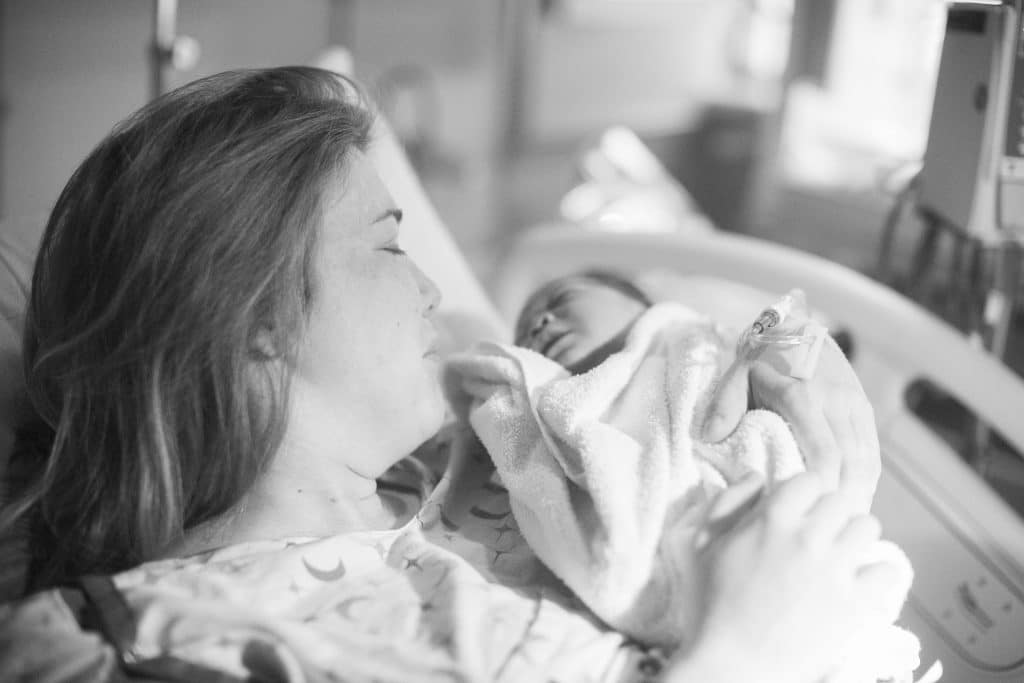 Woman just gave birth with her child and she is carrying it