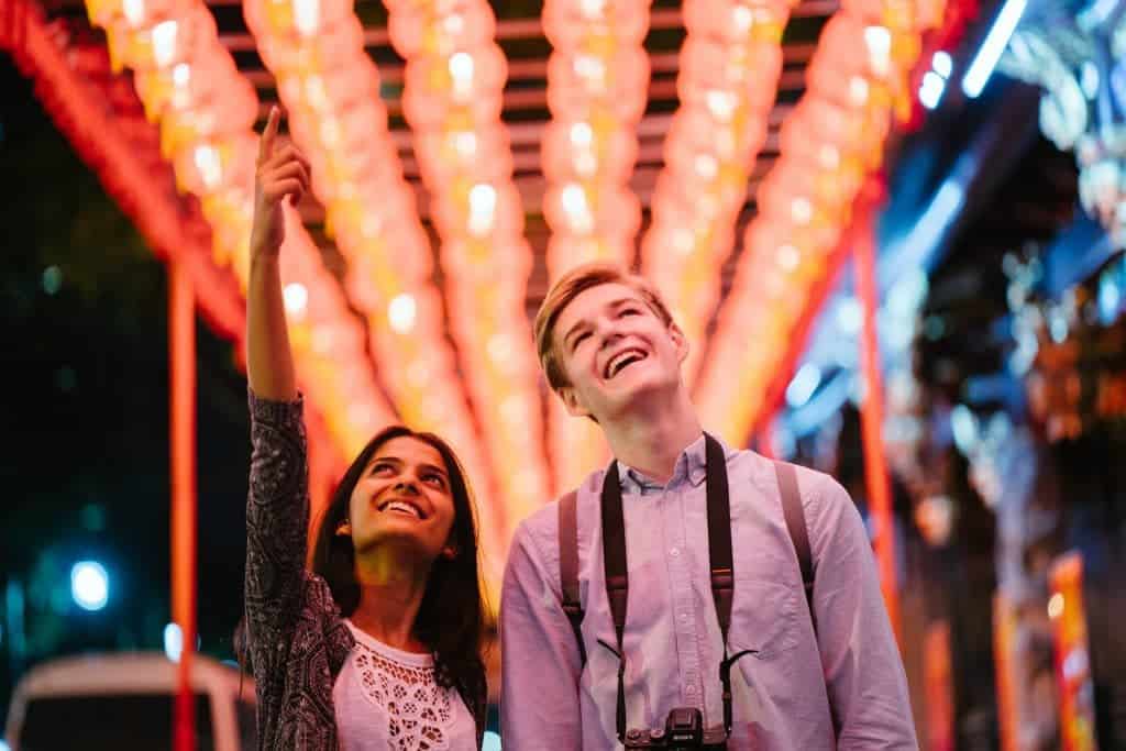 young couple happy while looking at the lights