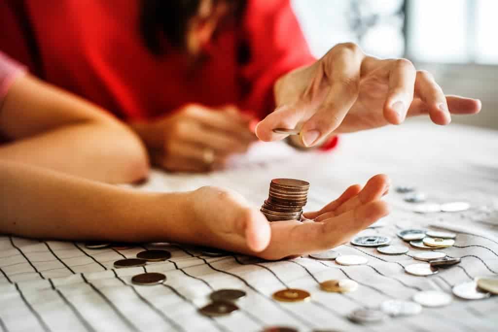 woman teaching her child about saving every penny