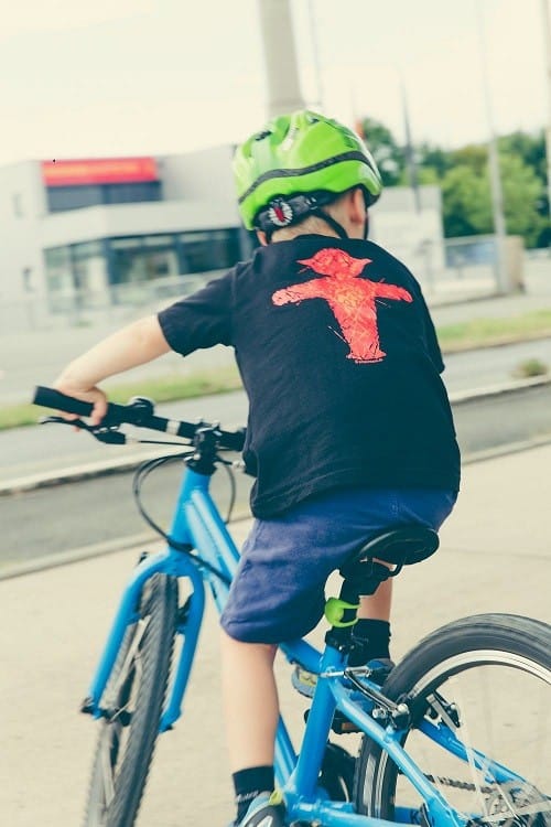 kids playing bike with green helmet