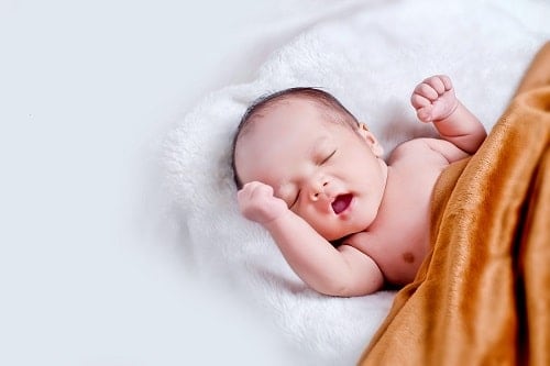 new born baby with brown blanket