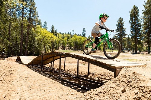 boy playing green bike
