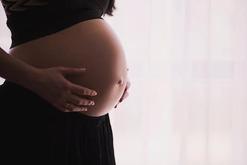 Pregnant woman wearing black pants and shirt