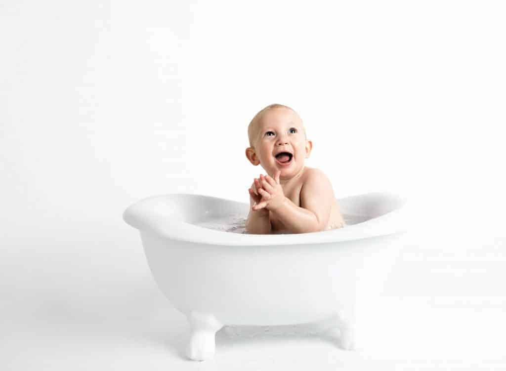 baby taking a bath on a tub