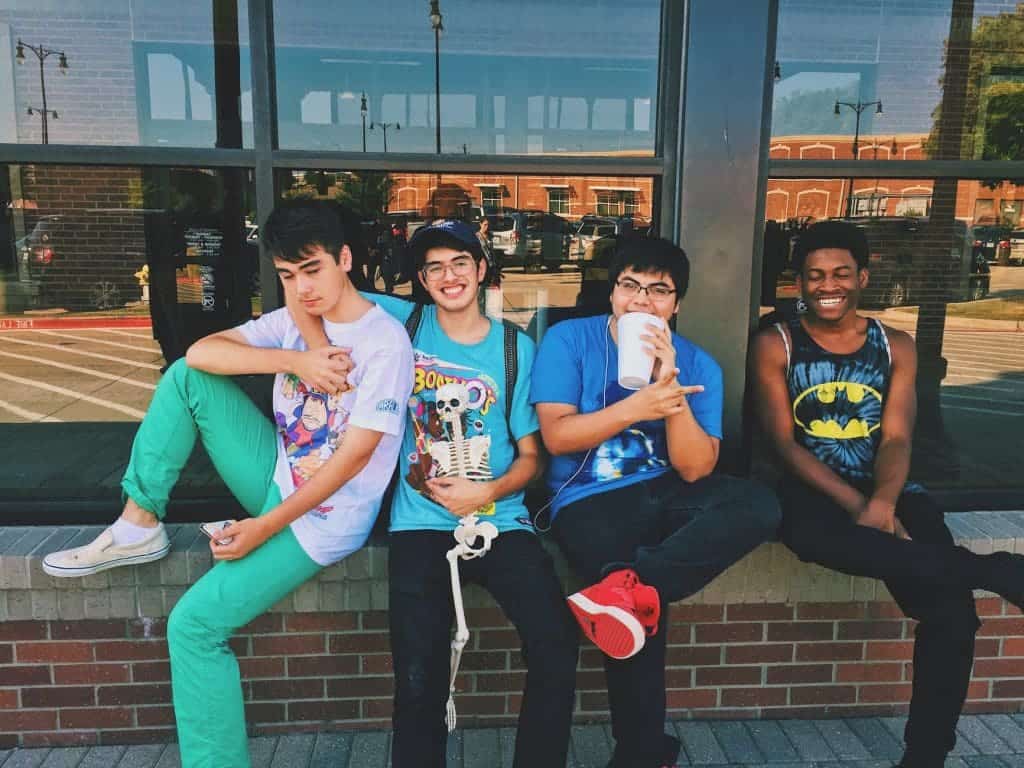 four boys hanging together