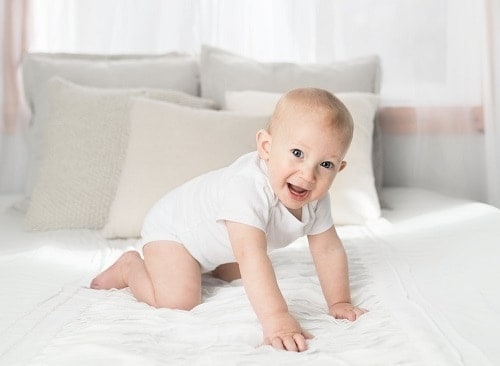happy baby in bed