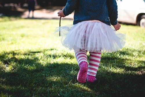 walking baby wearing tutu