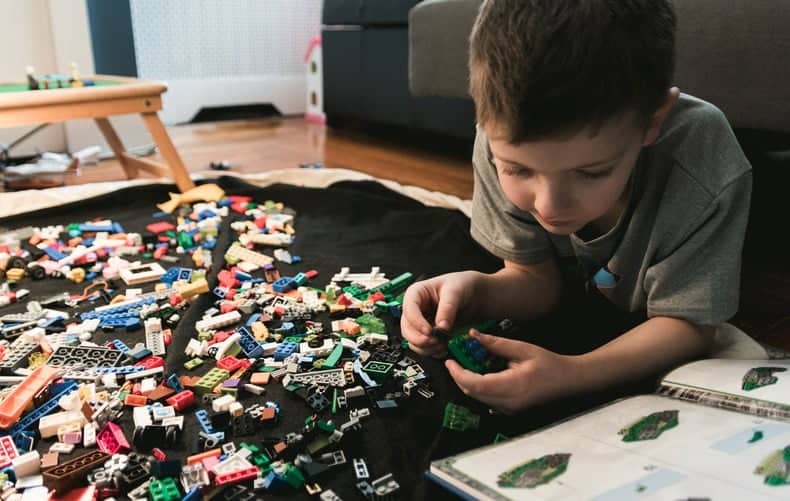 kid playing with lego