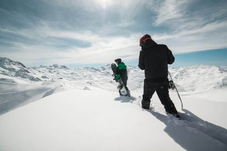 two man walking on the snow