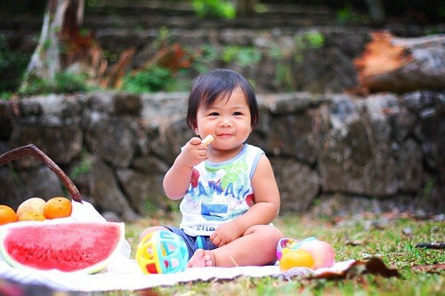 Baby sitting at the garden