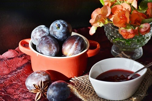 Plum purple beside bowl and spoon