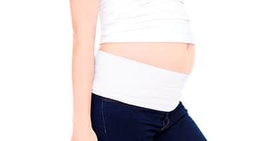 pregnant woman wearing a belly band folded in half