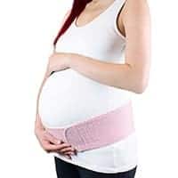 pregnant woman wearing pink maternity belt for support