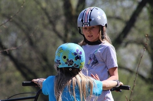 two girl wearing helmet
