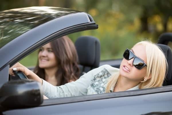 Blonde teen driving her convertible