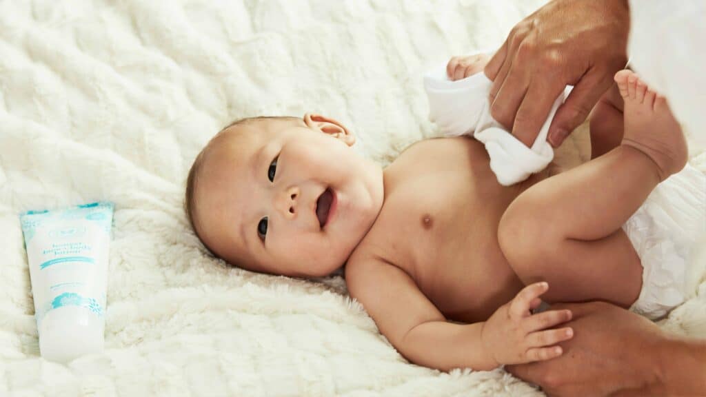 Baby in Diaper lying on bed