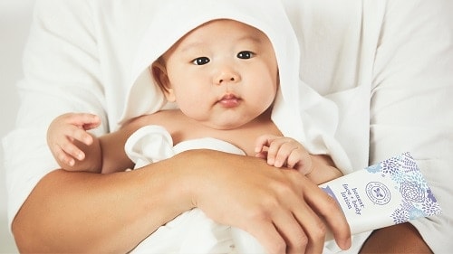 baby wearing white dress