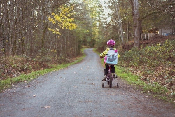Toodler Riding Bicycle with backpack