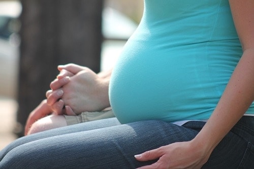 pregnant woman sitting with man