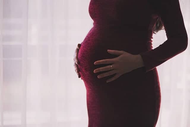 pregnant woman holding baby bump