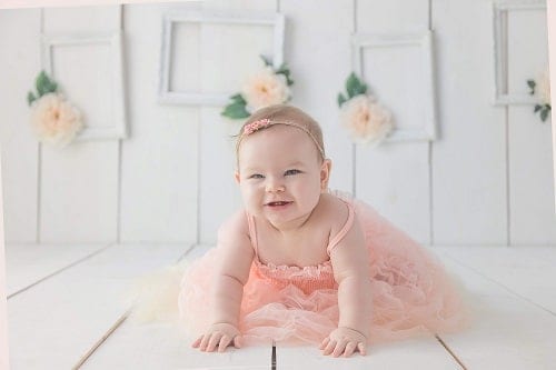Baby crawling in white floor