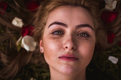 Freckled face with roses