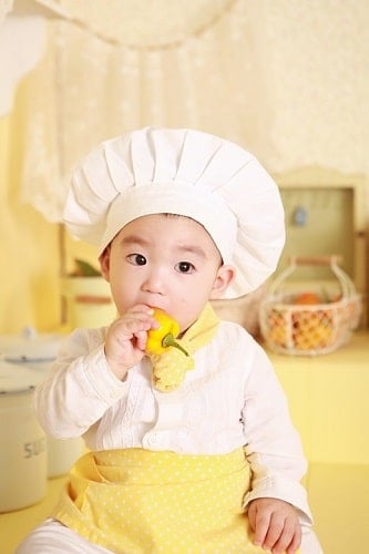 Baby Chef holding bell pepper