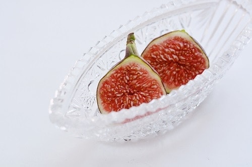 sliced red fruit in clear glass bowl