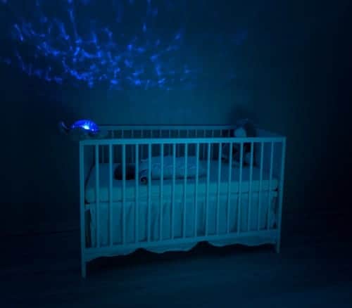 baby's white wooden crib lowlight