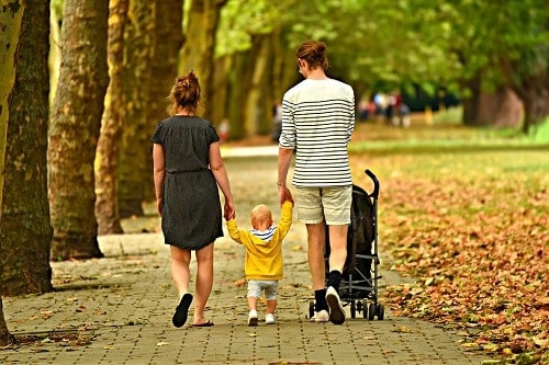 Woman man and child walking