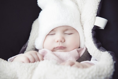 baby sleeping with covered blanket