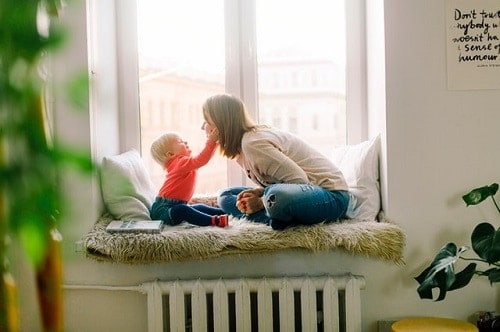 baby touching woman face