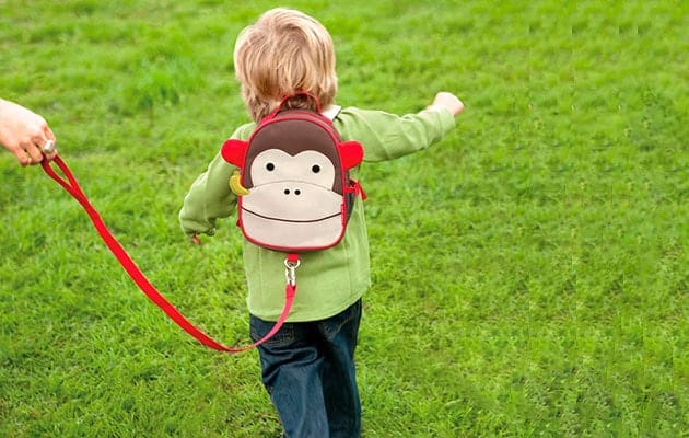 child-running-on-grass-attached-to-backpack-safety-leash.jpg