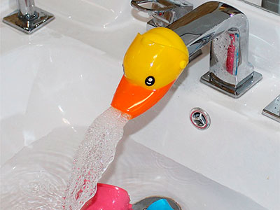 duck faucet extender with water flowing out into basin