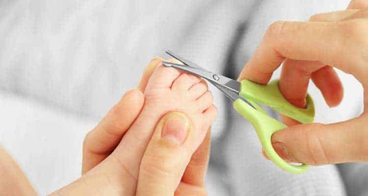cutting baby toenails with nail scissors