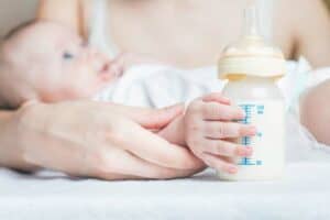 Baby with soy formula in baby bottle