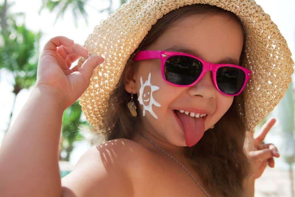Little girl with sunscreen protection on her cheeks