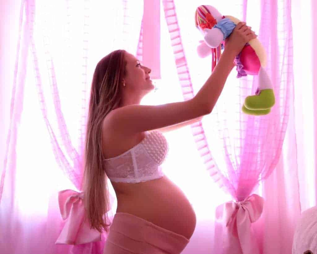 Pregnant woman holding a stuffed toy