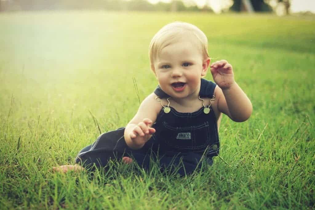 1 year old playing on grass